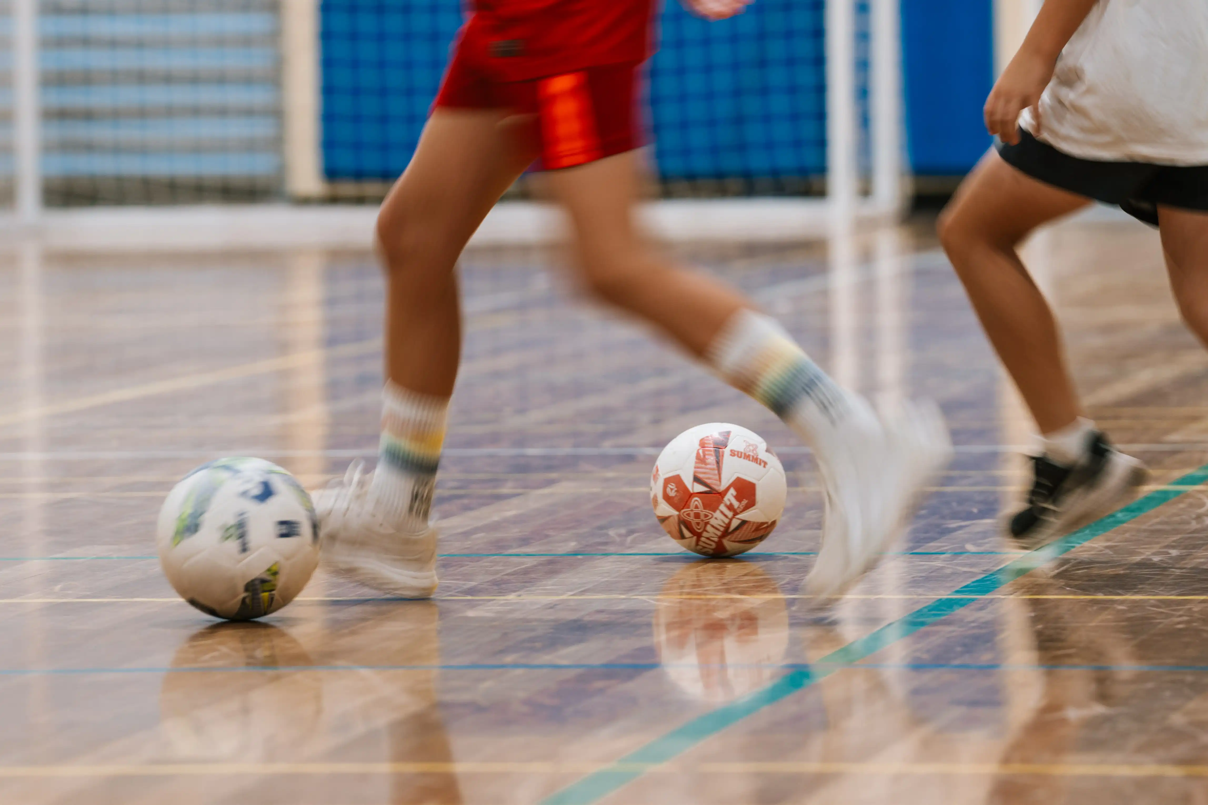 Feet and ball playing futsal. 